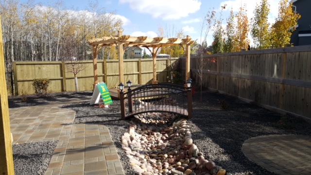 Aspen-Calgary-landscaping-backyard-pathway-deck-dry-creek-rocks-plants